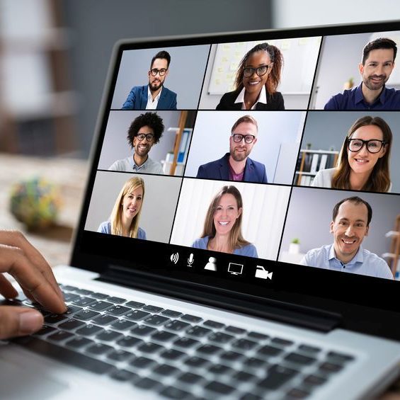 Man Working From Home Having Group Videoconference On Laptop